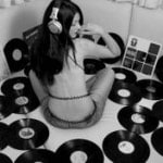 girl surrounded by vinyl records